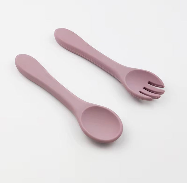 Nibble and Gnaw silicone spoon and fork set in assorted earthy tones, designed for little hands, made from safe, BPA-free, food-grade material. Pale Mauve 