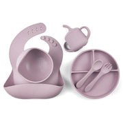 mauve silicone baby feeding set including a divided suction plate, bowl, bib with food catcher, sippy cup, spoon, and fork. Perfect for weaning and toddler feeding