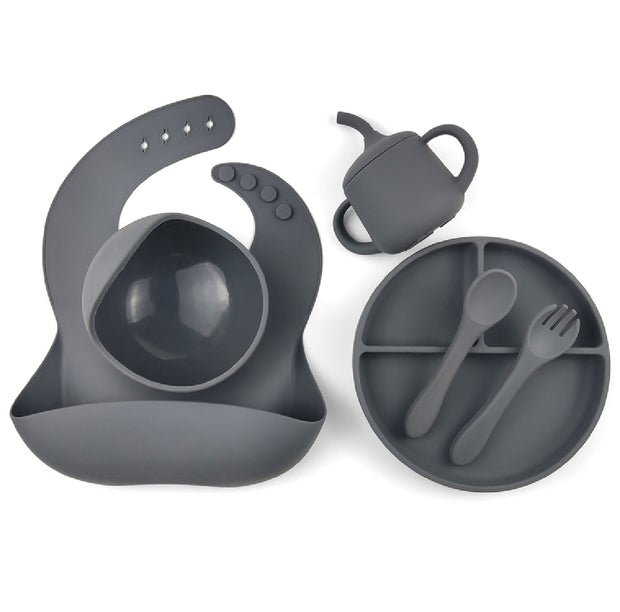 Dark Grey silicone baby feeding set including a divided suction plate, bowl, bib with food catcher, sippy cup, spoon, and fork. Perfect for weaning and toddler feeding