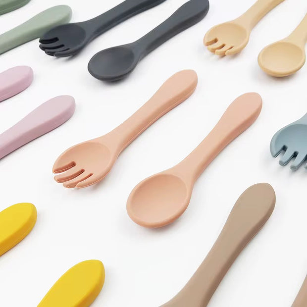 Nibble and Gnaw silicone spoon and fork set in assorted earthy tones, designed for little hands, made from safe, BPA-free, food-grade material.
